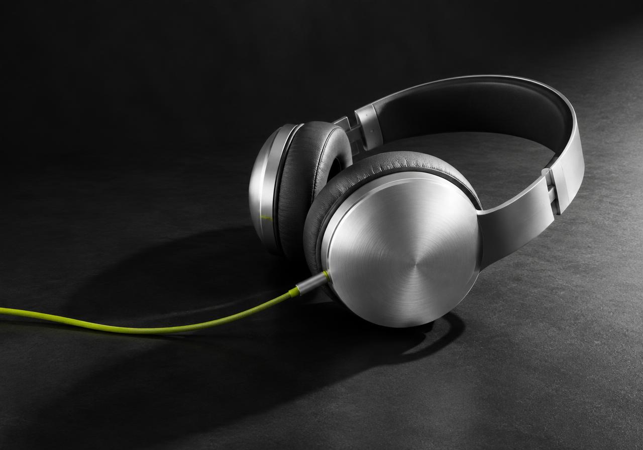 Illustrative silver headphones on a charcoal background